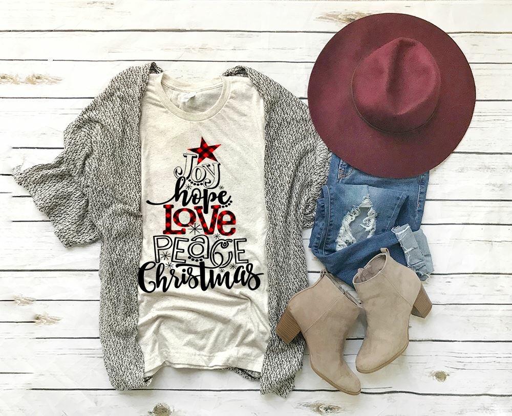 a shirt with the caption "Joy Hope Love Peace Christmas"  in the shape of a christmas tree